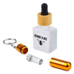 gold bee revival gift box with a bee revival kit open in front of a bee revival kit refill bottle